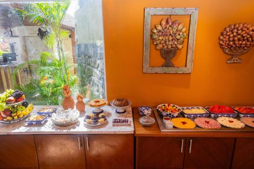 a table with a bunch of food on it at CASA Di VINA Boutique Hotel in Salvador