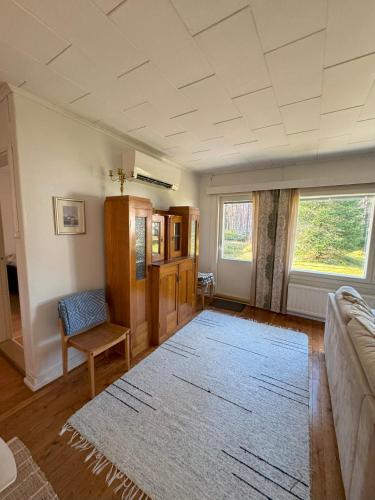 a living room with a couch and a rug at Villa Tyynelä in Sodankylä