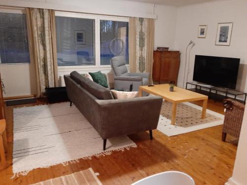 a living room with a couch and a table at Villa Tyynelä in Sodankylä