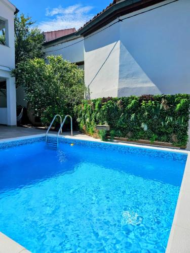 a large blue swimming pool next to a building at Beach Villa Ema in Rab