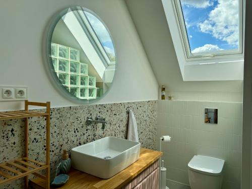 a bathroom with a sink and a mirror at Domek na Rybackiej in Swarzewo