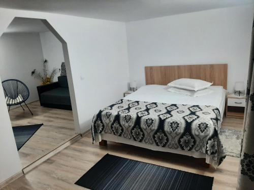 a bedroom with a bed with a comforter on it at Casa Anastasia in Bicaz