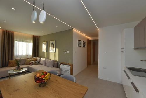 a living room with a couch and a table at Luxury Aparthotel Zadar in Zadar