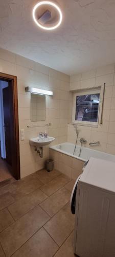 a bathroom with a sink and a bath tub at FeWo JoSa in Kappel-Grafenhausen