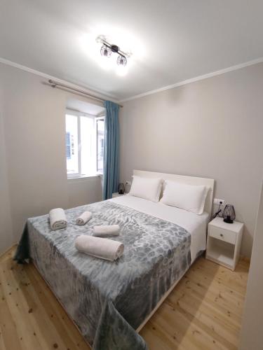 a bedroom with a large bed with two towels on it at Corfu Old Town Gregory in Corfu Town