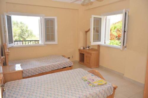 a room with two beds and two windows at قريه اللوتس العلمين الساحل الشمالي in El Alamein