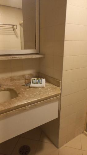 a bathroom with a sink and a mirror at 154apartamento lindo no itaim bibi in Sao Paulo