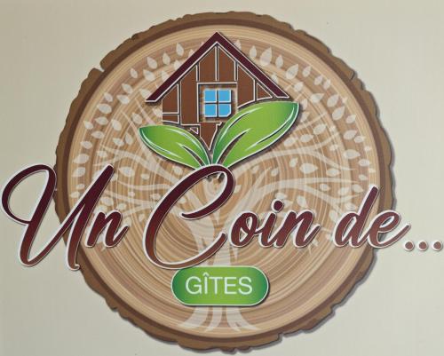 a wooden sign with a house on top of it at Un Coin De Gîtes in Sciez