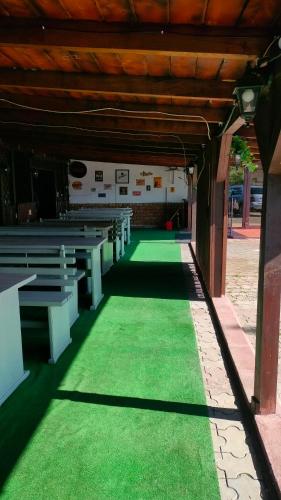 a row of pews in a church with green grass at Casa Emil in Floreşti