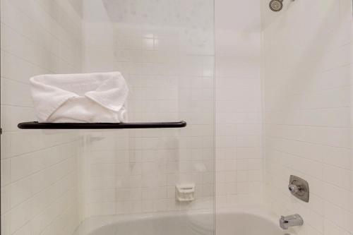 a bathroom with a tub and a towel on a shelf at Modern Alpine Getaway in Sun Valley
