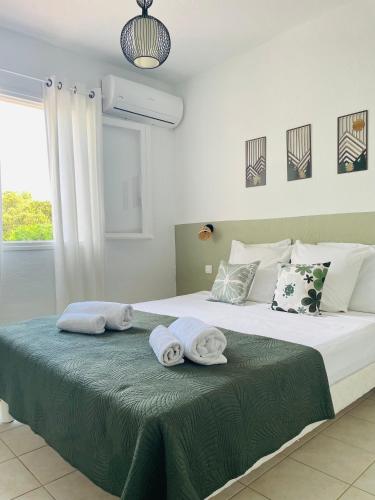 a bedroom with a large bed with towels on it at Fiori di Luna in Porto-Vecchio