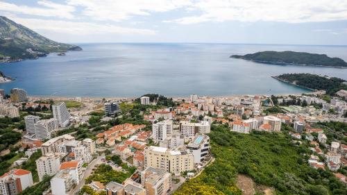 an aerial view of a city and a body of water at Modern Top Floor Sea View 3BR with Pools, Spa & Fitness in Becici