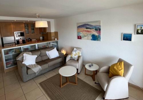 a living room with a couch and chairs and a table at Marina & sea view apartment at Port Grec in Empuriabrava