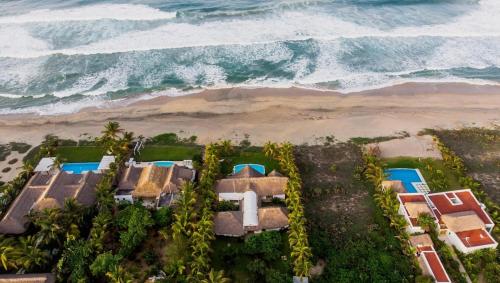an aerial view of a resort by the ocean at Villa Lumina - Beachfront Escape Private Pool, Spacious & Serene in Paso Hondo