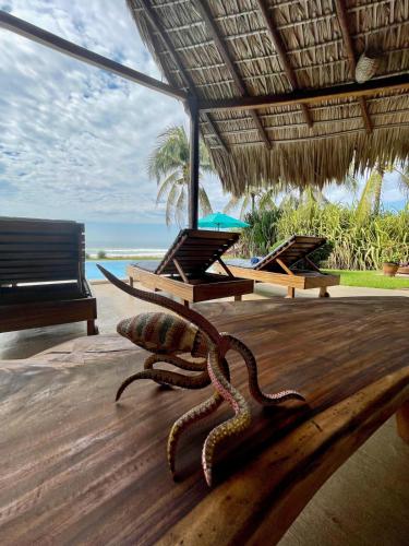 an octopus on the floor of a resort with a beach at Villa Lumina - Beachfront Escape Private Pool, Spacious & Serene in Paso Hondo