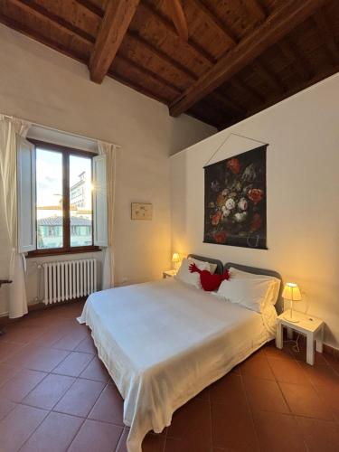 a bedroom with a large bed with a painting on the wall at Affittacamere Medusa in Florence