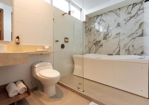 a bathroom with a toilet and a glass shower at Hotel Zi One Luxury in Cartagena de Indias
