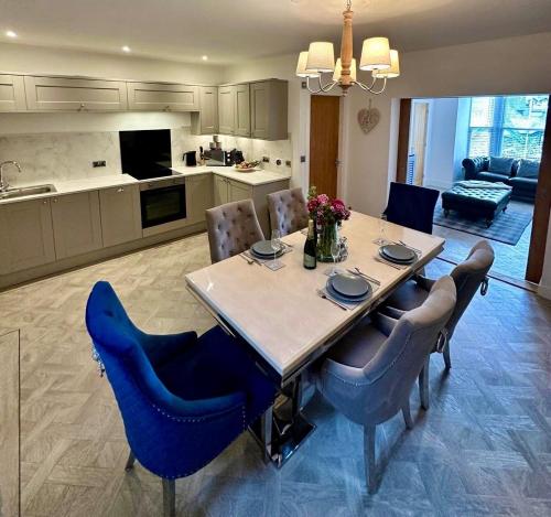 a kitchen and dining room with a table and chairs at Luxury Pet Friendly 3 Bedroom Home with Copper Bath in Bowness-on-Windermere