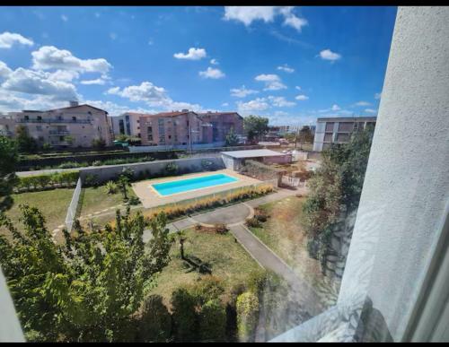 a view of a swimming pool from a building at Stunning T2 pool box-Meyzieu Gare-Stade-Eurexpo in Meyzieu