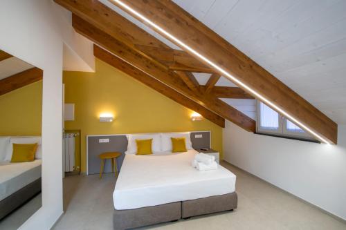 a bedroom with two beds in a attic at Rossy Palace - Amalficoast Suites in Agerola