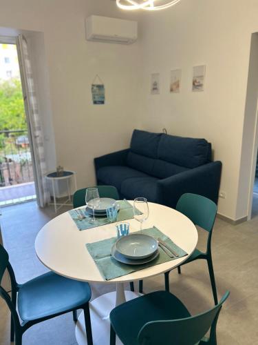 a living room with a table and chairs and a couch at Casa Giulé in Imperia