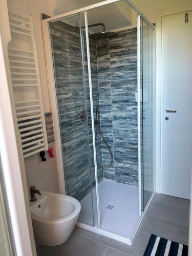 a bathroom with a shower and a toilet and a sink at Casa Giulé in Imperia