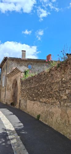 a stone building with an archway on the side of a road at Charmant studio Van Gogh in Chabeuil