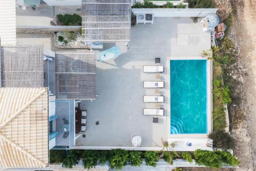 an overhead view of a swimming pool next to a house at Villa Etoni, amazing sea views, infinity pool in Kalamitsi
