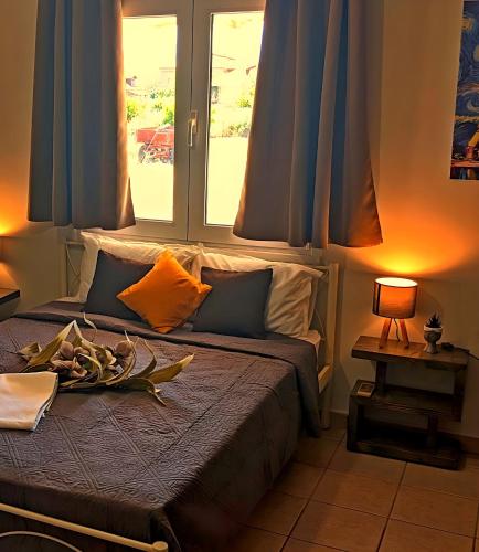 a bedroom with a bed with blue curtains at Summer House Rocinante 2 in Vromerí