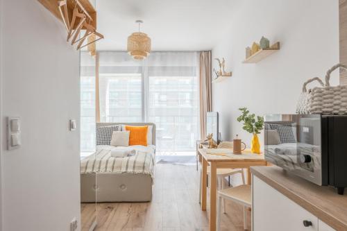 a living room with a couch and a window at LILY APART - Foodhall & Rooftop Terrace in Gdańsk
