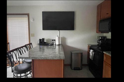 a kitchen with a counter top and a kitchen with a microwave at STAIRS OPTIONAL! Lakefront! Pool! On Water! Convenient Fishing! in Osage Beach