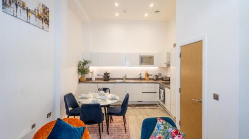 a kitchen and dining room with a table and chairs at Mega7 Spacious 2Bedroom Apartment, 2 Bathrooms, Balcony and Free Parking in Manchester