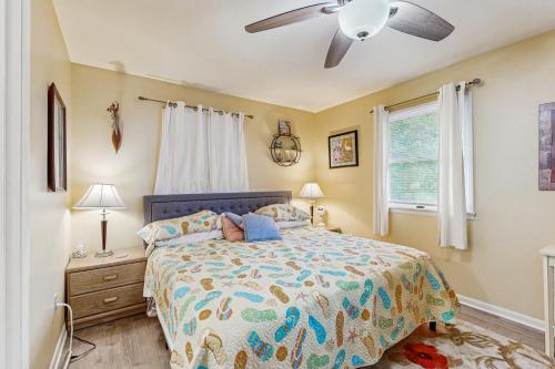 a bedroom with a bed and a ceiling fan at Beach Retreat in Ocean City