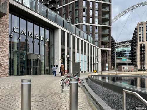 a building with people walking in front of it at Wembley Stadium Modern 1 Bed Apartment With Amazing Views in London