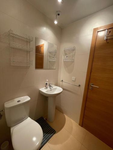 a bathroom with a toilet and a sink at Murcia Golf & Holidays Apartment in Alhama de Murcia