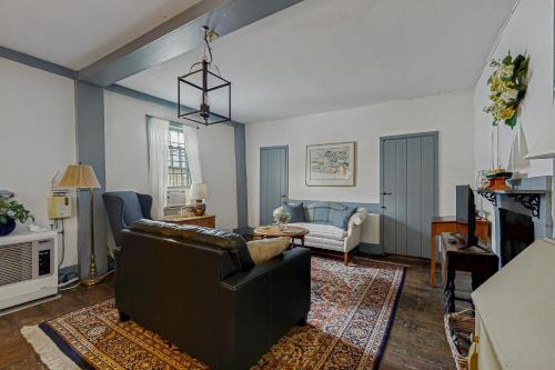 a living room with a couch and a table at Sunrise on the Sheepscot in Wiscasset