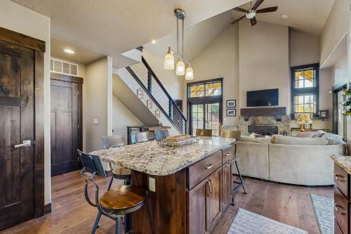 a kitchen with a large island and a living room at Tamarack Townhouse in Donnelly