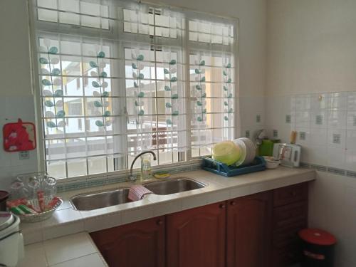 a kitchen with a sink and a window at Couple place in Port Dickson