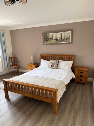 a bedroom with a large bed with white sheets and pillows at The Cottage Inn in Llandeilo