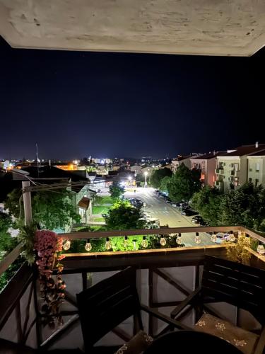 a view of a city at night from a balcony at Magnolia in Ljubuški