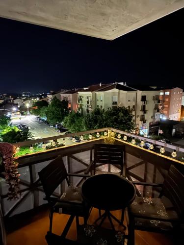 a balcony with a view of a city at night at Magnolia in Ljubuški