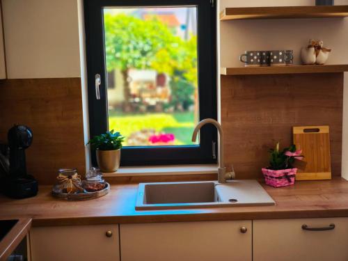 a kitchen counter with a sink and a window at Maella garden in Zadar