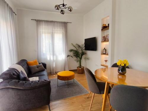 a living room with a couch and a table at Maella garden in Zadar