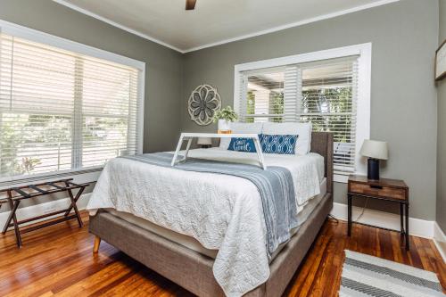 a bedroom with a bed and two windows at C'est La Vie - make memories at our cozy bungalow in St Petersburg