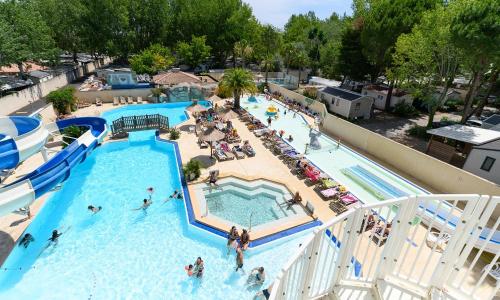 une vue aérienne d'une piscine dans un complexe hôtelier dans l'établissement L'Eden - Mobil home 2 chambres 6 personnes Piscine, au Grau-du-Roi