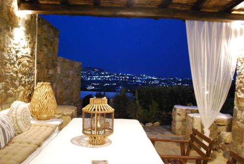 a room with a table and a window with a view at Blue Island Maisonette with Sharing Pool in Mýkonos City