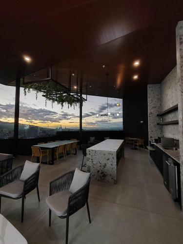 a room with chairs and a table with a view at Valle de Escalante in San José