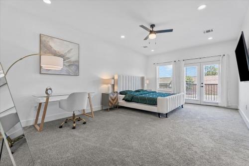 un dormitorio con una cama y un escritorio en High Style in H-Town with Luxury near Downtown, en Houston