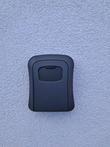 a black object on the side of a wall at House Virginia in Santa Cruz