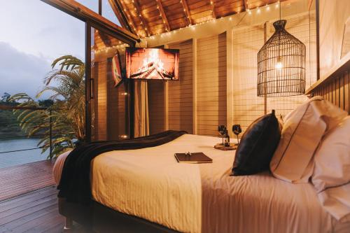 a bedroom with a bed with a bird cage on it at KABINE in El Peñol